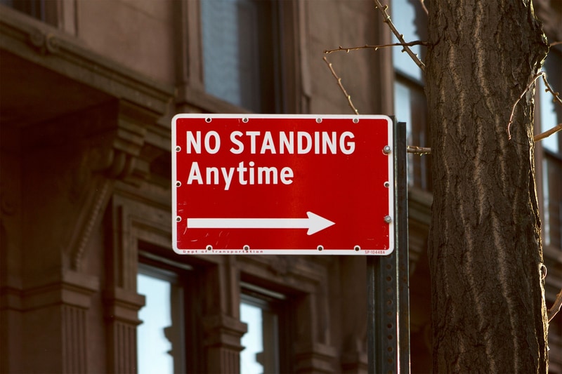 Parking sign reading No Standing with an arrow in Brooklyn, New York City