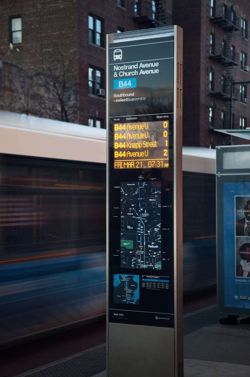 Wayfinding and bus time totem with Helvetica for the NYC DOT Walk NYC pedestrian wayfinding program in Brooklyn, New York City
